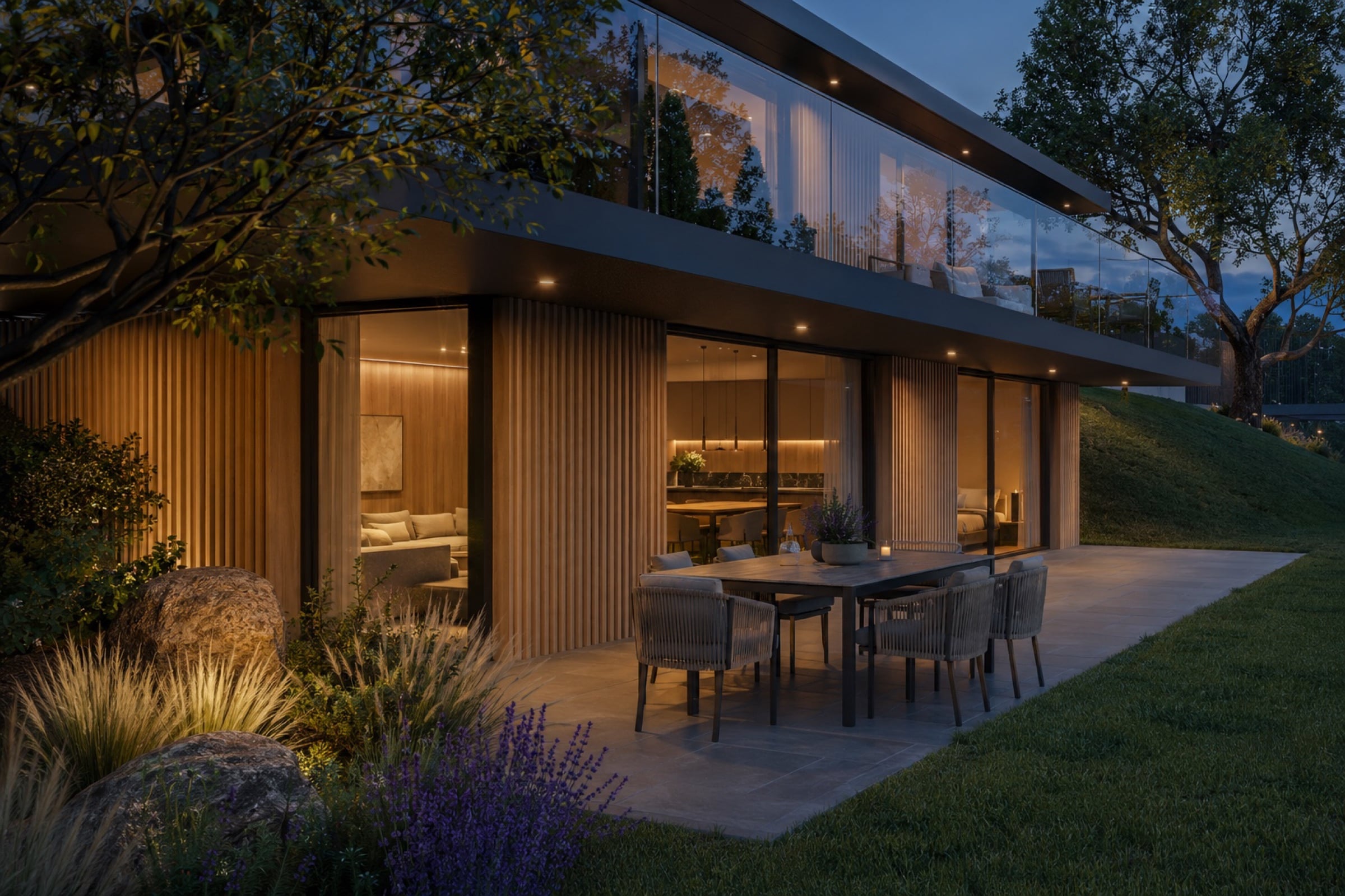 Garden storey of Villa 174/15 on an evening, dining table on the lawn terrace